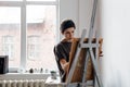 Female artist in her spacious white studio working with watercolor painting Royalty Free Stock Photo