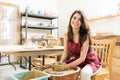 Female Artist Making Clay Pot On Pottery Wheel