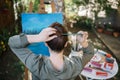 Female artist making hairstyle with paintbrush outdoor Royalty Free Stock Photo