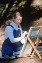 Female artist painting en pleine air