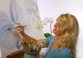 A female artist painting in her studio Royalty Free Stock Photo