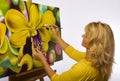 A female artist painting in her studio