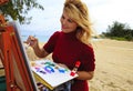 Female artist painting outdoors