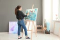 Female artist painting picture in workshop Royalty Free Stock Photo