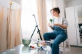 female artist sitting in front of easel, painting picture with inspiration, drawing on canvas with paintbrush, palette