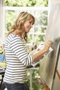 Female Artist Working On Painting In Studio Royalty Free Stock Photo
