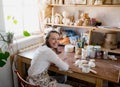 a female artist works in a workshop. production of environmentally friendly wooden toys made of wood. Royalty Free Stock Photo