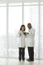 Female Asian doctor with African American doctor with tablet Royalty Free Stock Photo