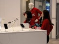 Female asian exhibitors in red advertising JVC earbuds at CES
