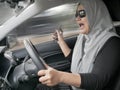 Female Driver Making a Call While Driving a Car