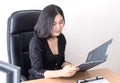 Female Asian office worker is checking report