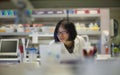 Female Asian Scientist Concentrating at a Biomedical Laboratory