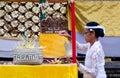 A female assistant priests prepare the offering altar at the Piodalan event, in Ubud, Bali, Indonesia