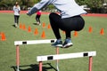 Female athlete bounds over a hurdle Royalty Free Stock Photo