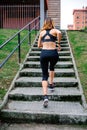 Female athlete climbing stairs outdoors Royalty Free Stock Photo