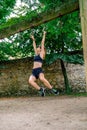 Woman doing monkey exercises on rings Royalty Free Stock Photo