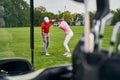 Female athlete in a face mask learning golf swing fundamentals