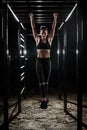 Female athlete with fit body hanging on the pullup bar Royalty Free Stock Photo