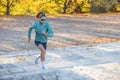 Female athlete with a fit body starts a challenging run up the stairs Royalty Free Stock Photo