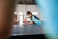 Female athlete holding paddle and ball while serving Royalty Free Stock Photo