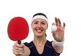 Female athlete holding table tennis paddle and ball Royalty Free Stock Photo