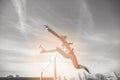 Female athlete jumping above the hurdle during the race Royalty Free Stock Photo