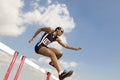 Female Athlete Jumping Hurdle Royalty Free Stock Photo