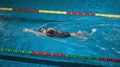 Female athlete performing the backstroke swim technique Royalty Free Stock Photo