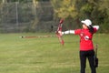 Female athlete practicing archery in stadium Royalty Free Stock Photo