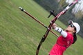 Female athlete practicing archery in stadium Royalty Free Stock Photo