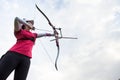 Female athlete practicing archery in stadium Royalty Free Stock Photo