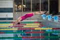 Female athlete preparing for a dive start and jumping into the pool Royalty Free Stock Photo