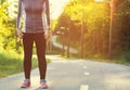 Female athlete preparing for a jog on a forest path Royalty Free Stock Photo