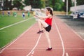 Female athlete preparing legs for cardio workout. Fitness runner doing warm-up routine. woman runner warm up outdoor Royalty Free Stock Photo