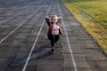 Female athlete preparing legs for cardio workout. Fitness runner doing warm-up routine. woman runner warm up outdoor. athlete Royalty Free Stock Photo