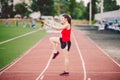 Female athlete preparing legs for cardio workout. Fitness runner doing warm-up routine. woman runner warm up outdoor Royalty Free Stock Photo