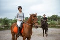 female athlete riding horse to train with male athlete Royalty Free Stock Photo