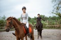 female athlete riding horse to train with male athlete Royalty Free Stock Photo