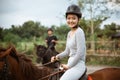 female athlete riding horse to train with male athlete Royalty Free Stock Photo