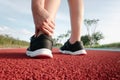 Female Athlete Runner Ankle Injury While Jogging in Running Track, Sport Woman Having Pain Her Ankles During Exercise Running. Royalty Free Stock Photo