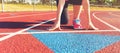 Female athlete on the starting line of a stadium track Royalty Free Stock Photo