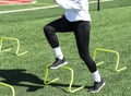 Female athlete stepping over yellow mini hurdles Royalty Free Stock Photo