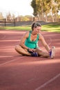 Female athlete stretching on a running track Royalty Free Stock Photo