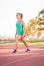 Female athlete stretching on a running track Royalty Free Stock Photo