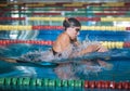 Female athlete swimming in breaststroke style in the pool lane Royalty Free Stock Photo