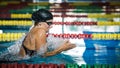 Female athlete swimming in breaststroke style in the pool lane Royalty Free Stock Photo