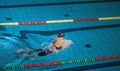 Female athlete swimming in breaststroke style in the pool lane Royalty Free Stock Photo