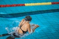 Female athlete swimming in breaststroke style in the pool lane Royalty Free Stock Photo