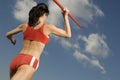 Female Athlete Throwing Javelin Against Sky