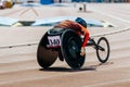 female athlete in wheelchair racing track stadium in para athletics competition